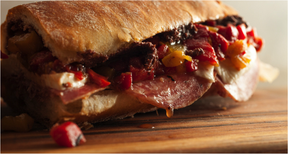 Alidoro deli sandwich with various meats, cheese, and peppers