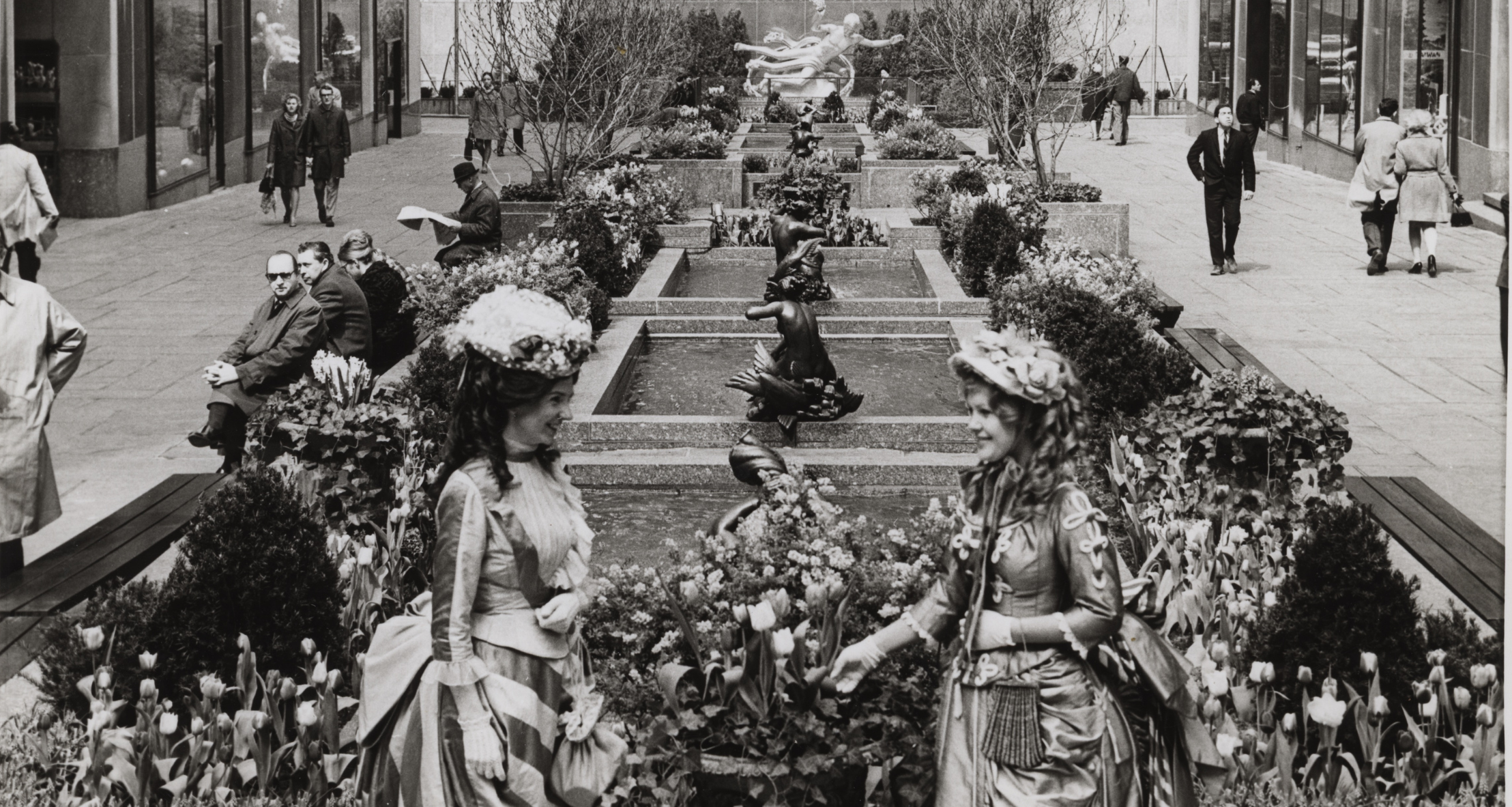 Rockefeller Center employees Colette O’Mahony (left) and Eileen McGrath (right) dress up in historical fashions to celebrate the opening of a garden honoring the 100th anniversary of the Metropolitan Museum of Art’s charter