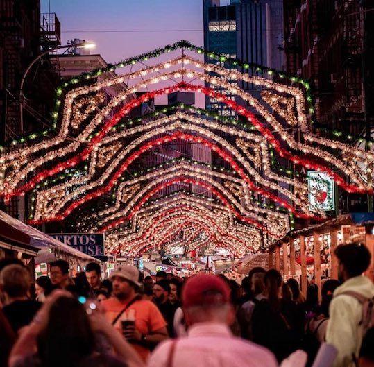 The Feat of San Gennaro 2019 attendees stroll under decorative arches