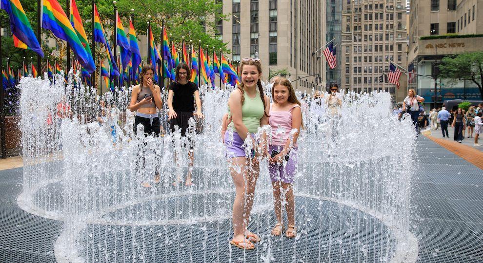 Two children playing with artist Jeppe Hein's "Changing Spaces" installation at Rockefeller Center