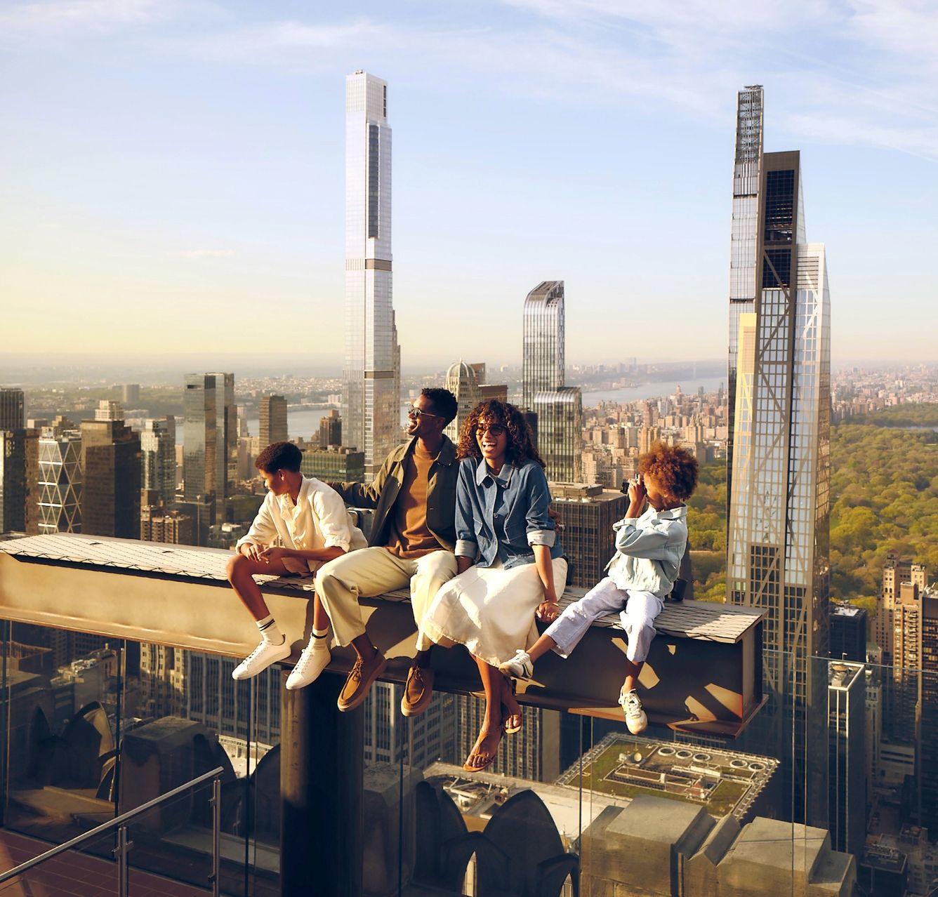 a family riding the beam at top of the rock