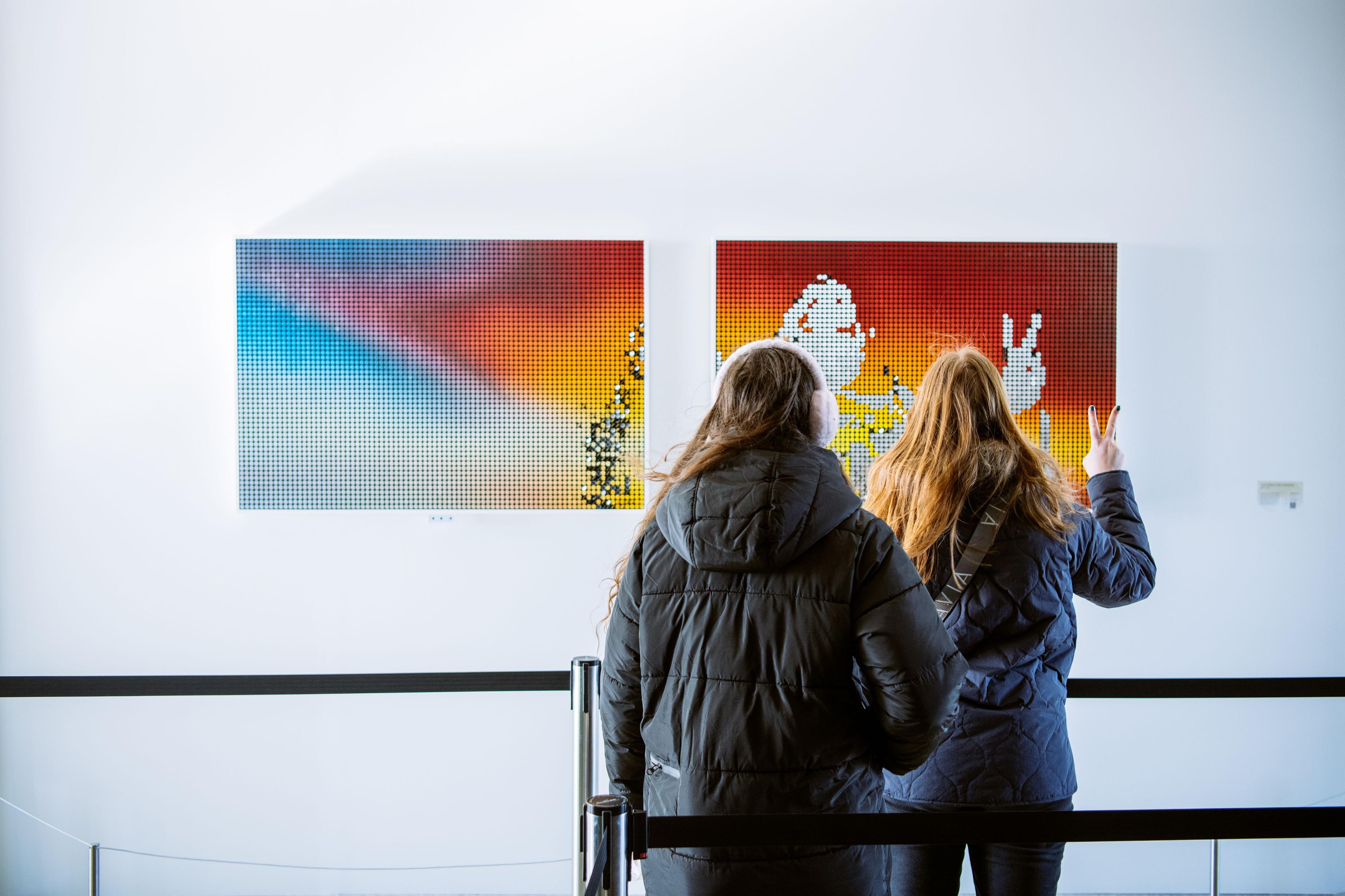 Two people interacting with Breakfast Studio's kinetic sculpture at Top of the Rock
