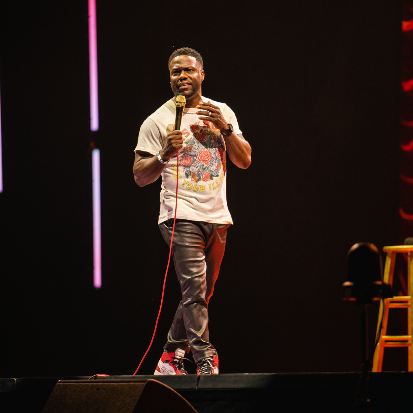 Comedian Kevin Hart performing on a stage
