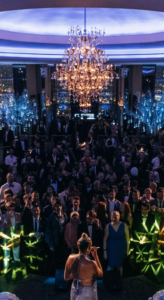 Guests at an event in the Rainbow Room beneath its chandelier