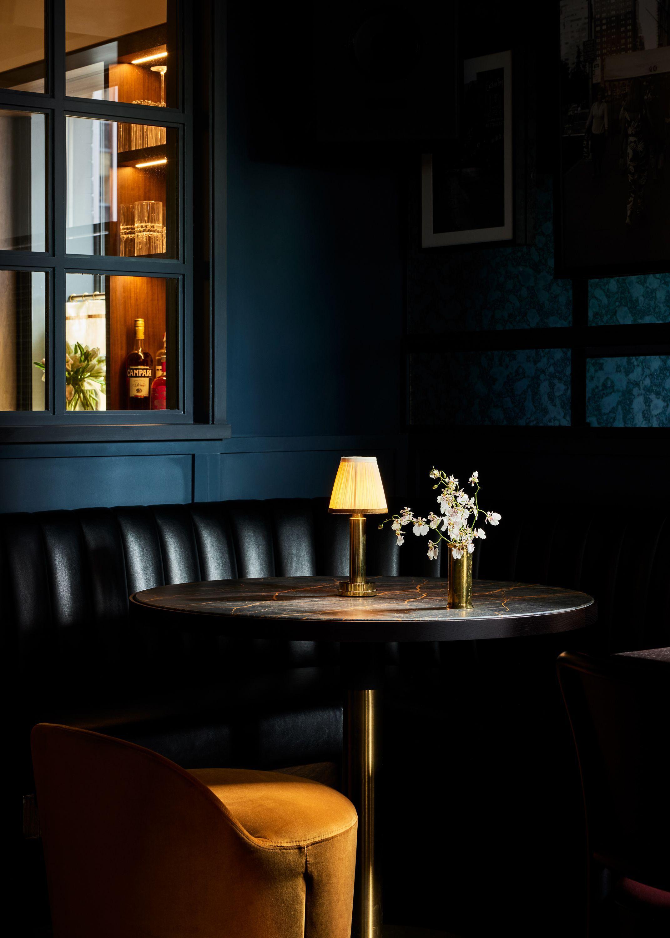 View of a corner booth at Pebble Bar with mood lighting