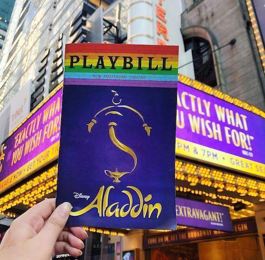 Aladdin Playbill in front of the New Amsterdam Theatre