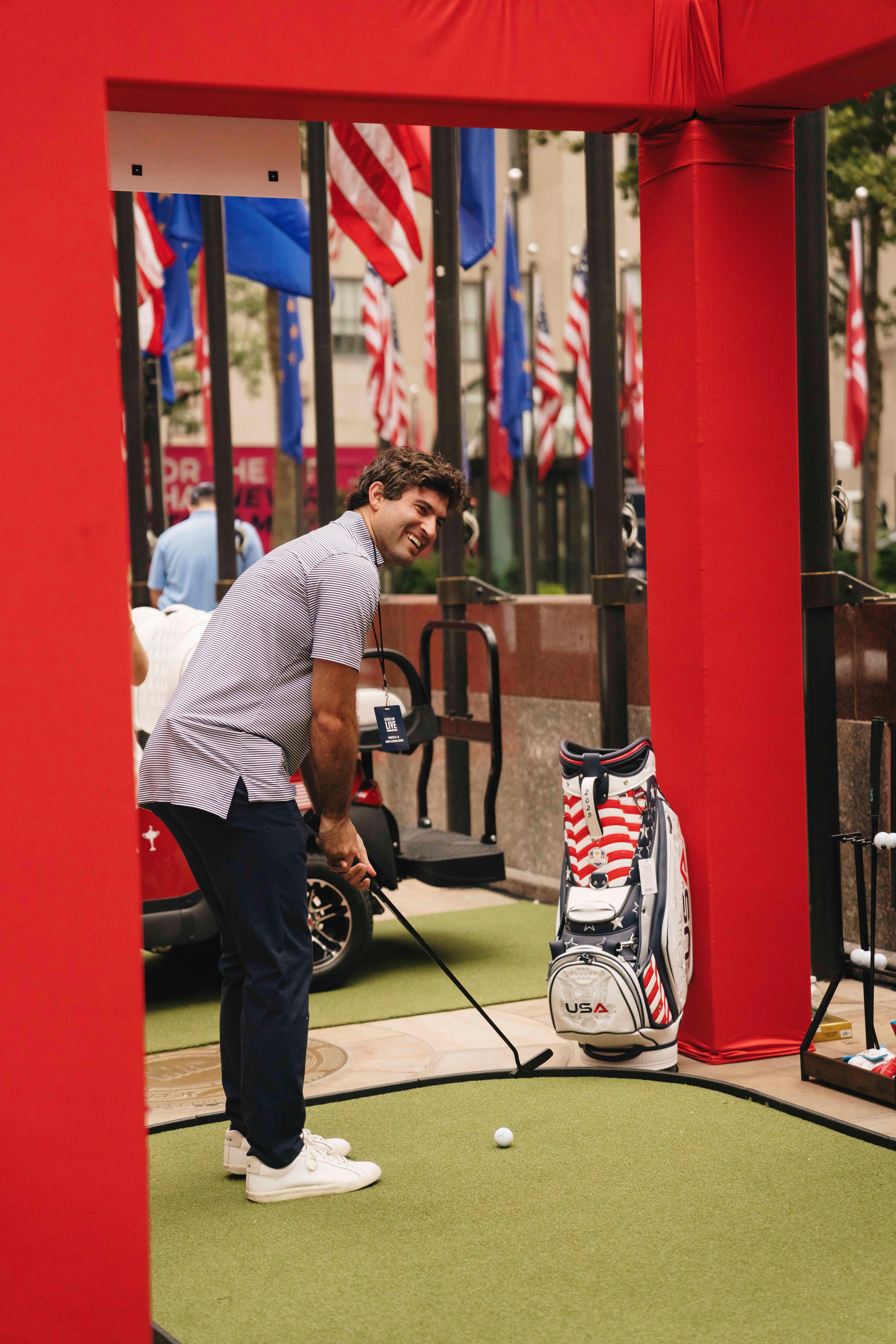 man playing golf at rockefeller center
