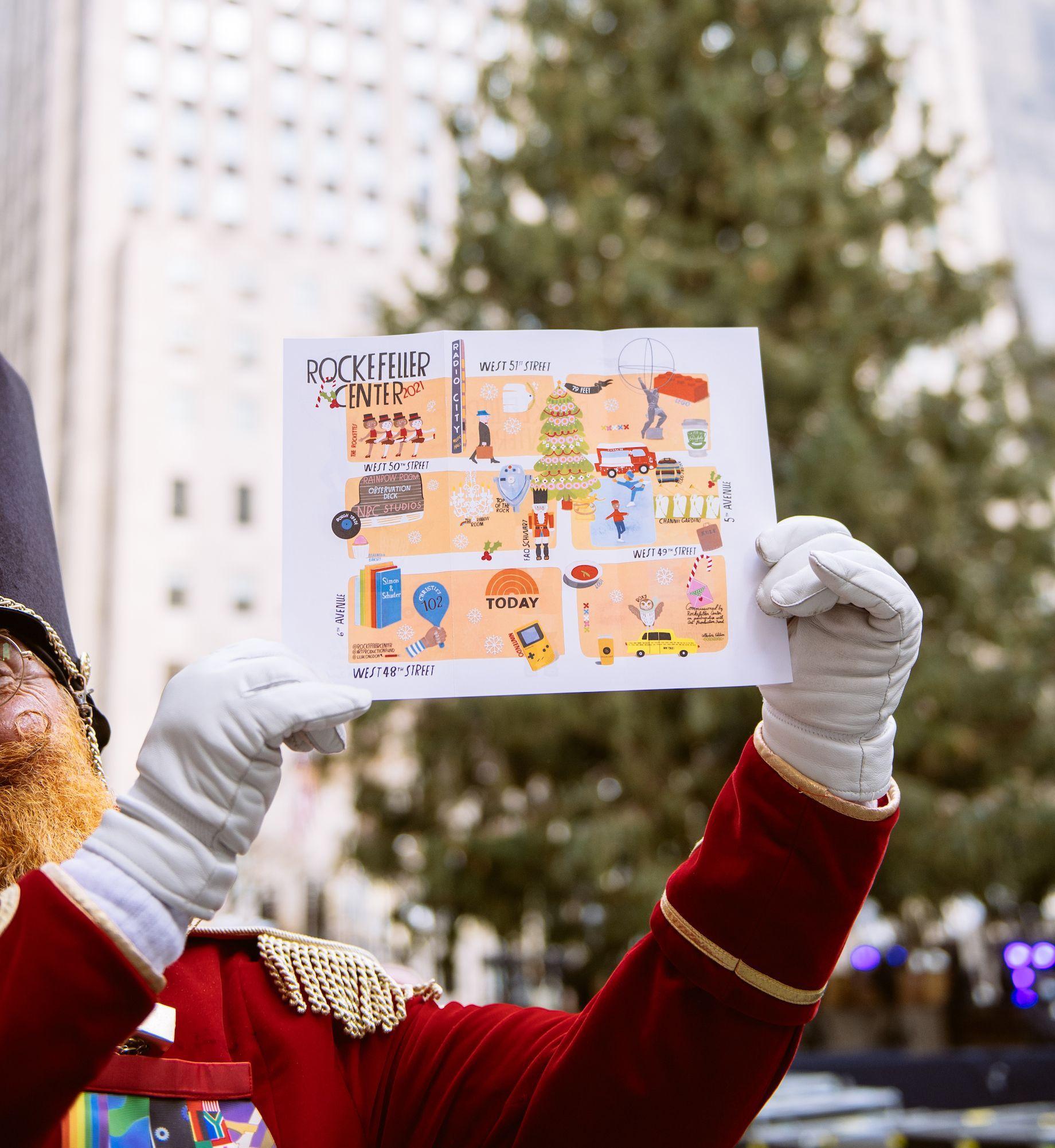 Person holding up the 2021 holiday map designed by Lisa Congdon