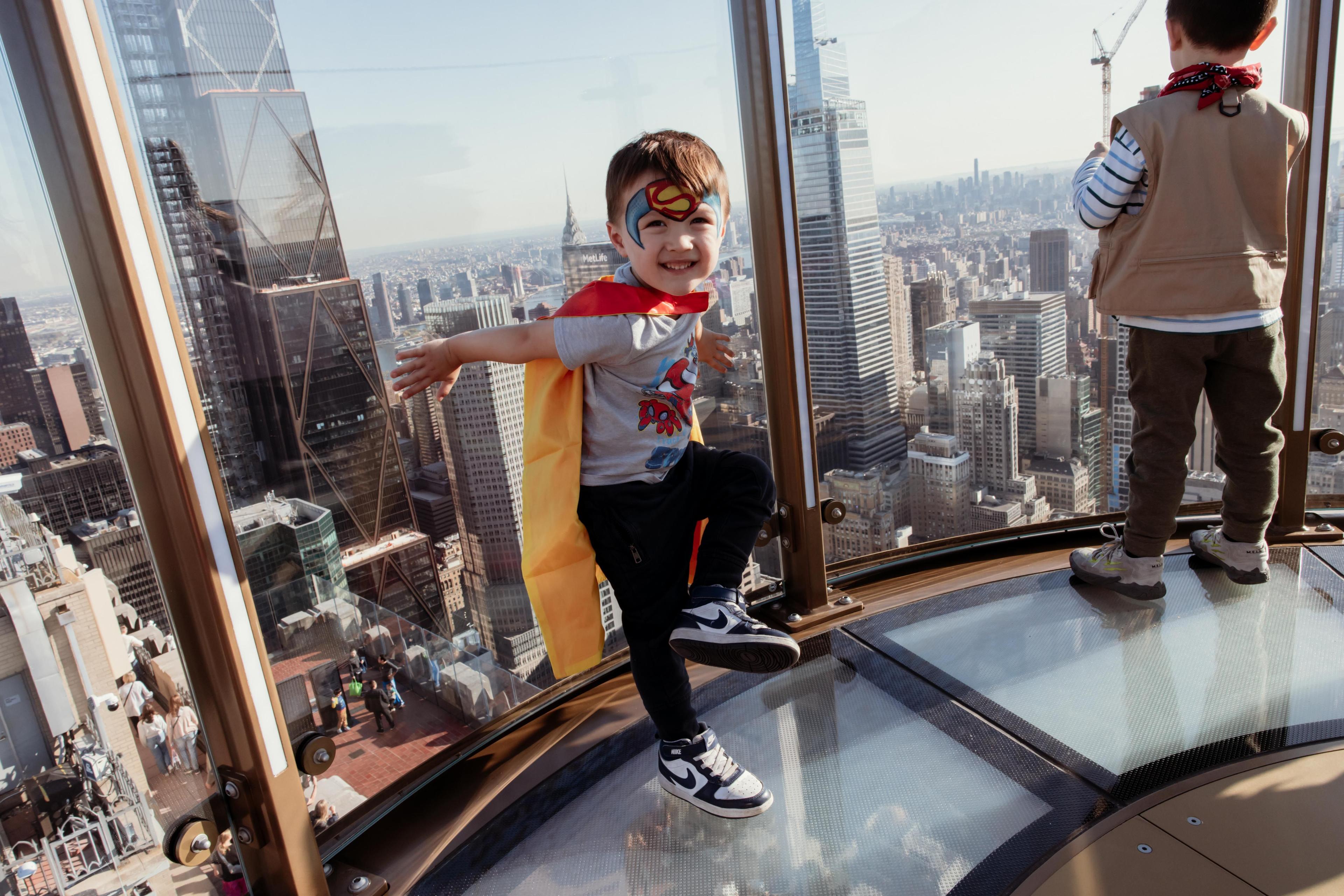 a kid with face painting at top of the rock