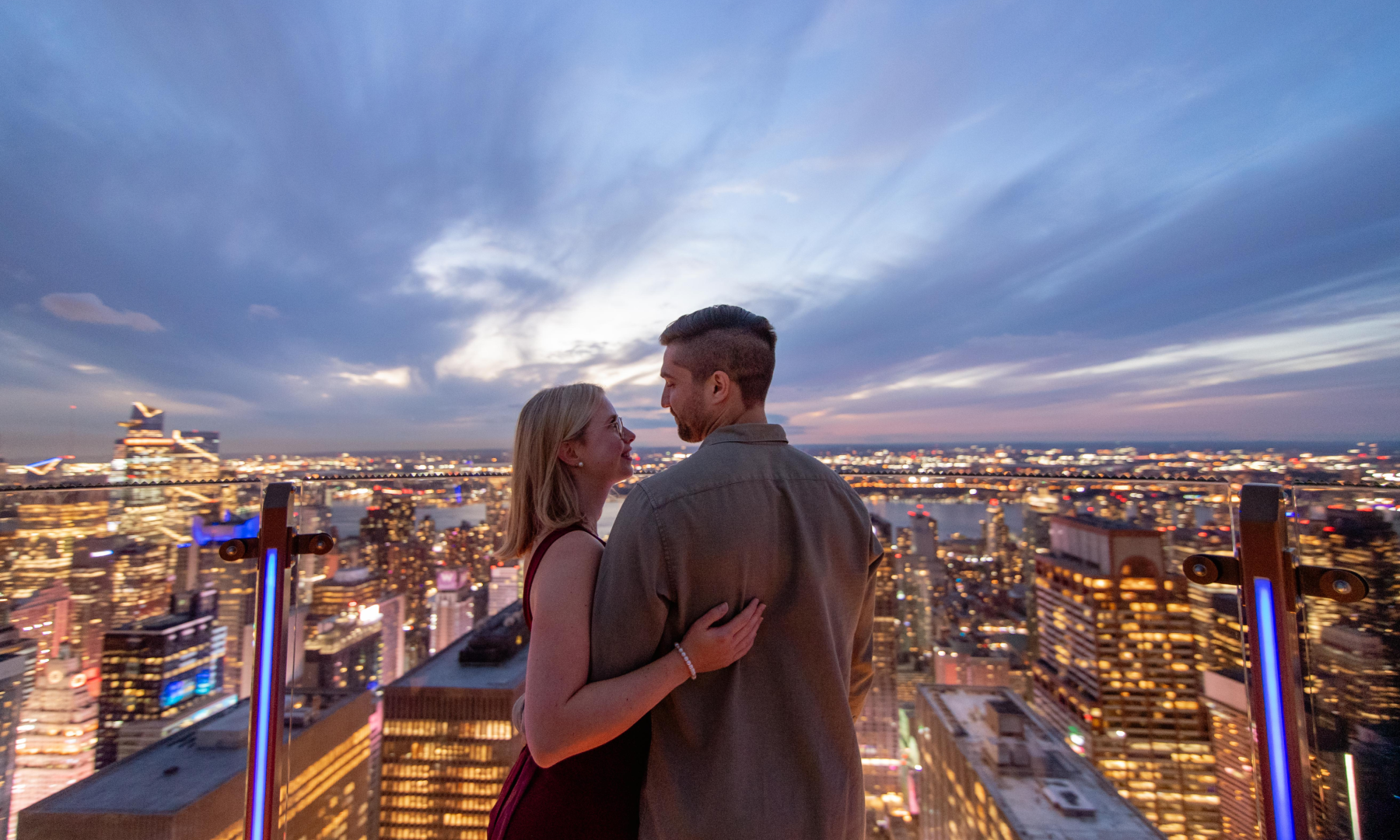 A couple looking at the view of New York City from SKYLIFT at Top of the Rock