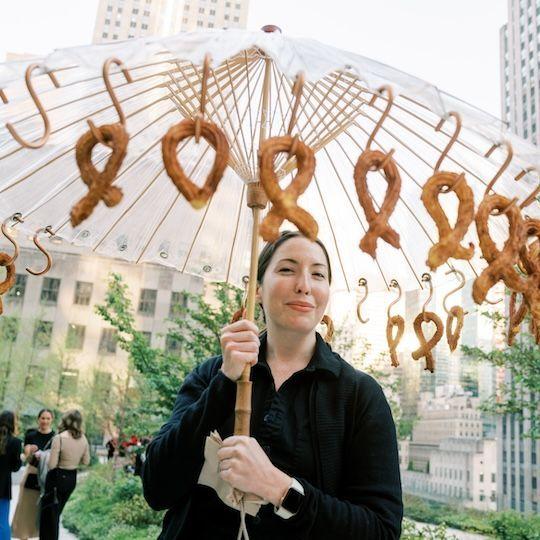 Server holding an umbrella of pretzels at Radio Park