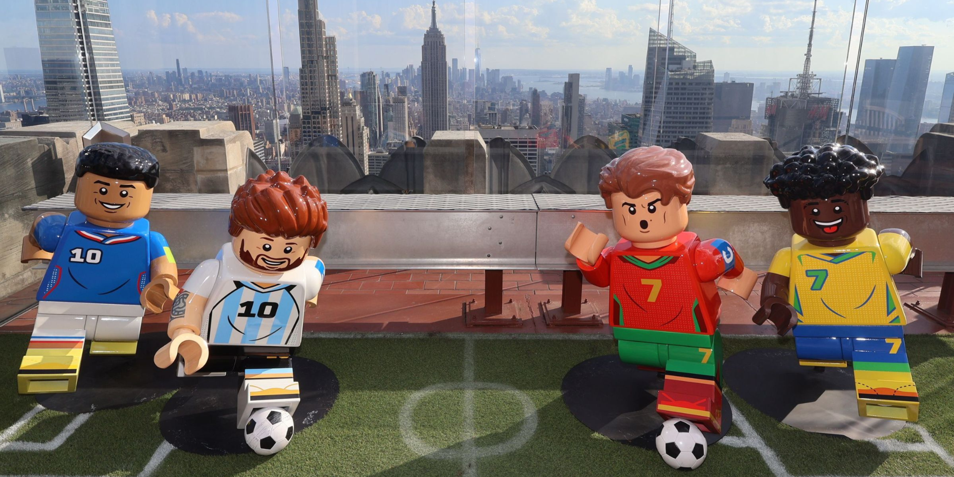 a family smiling on the beam with lego figures at top of the rock