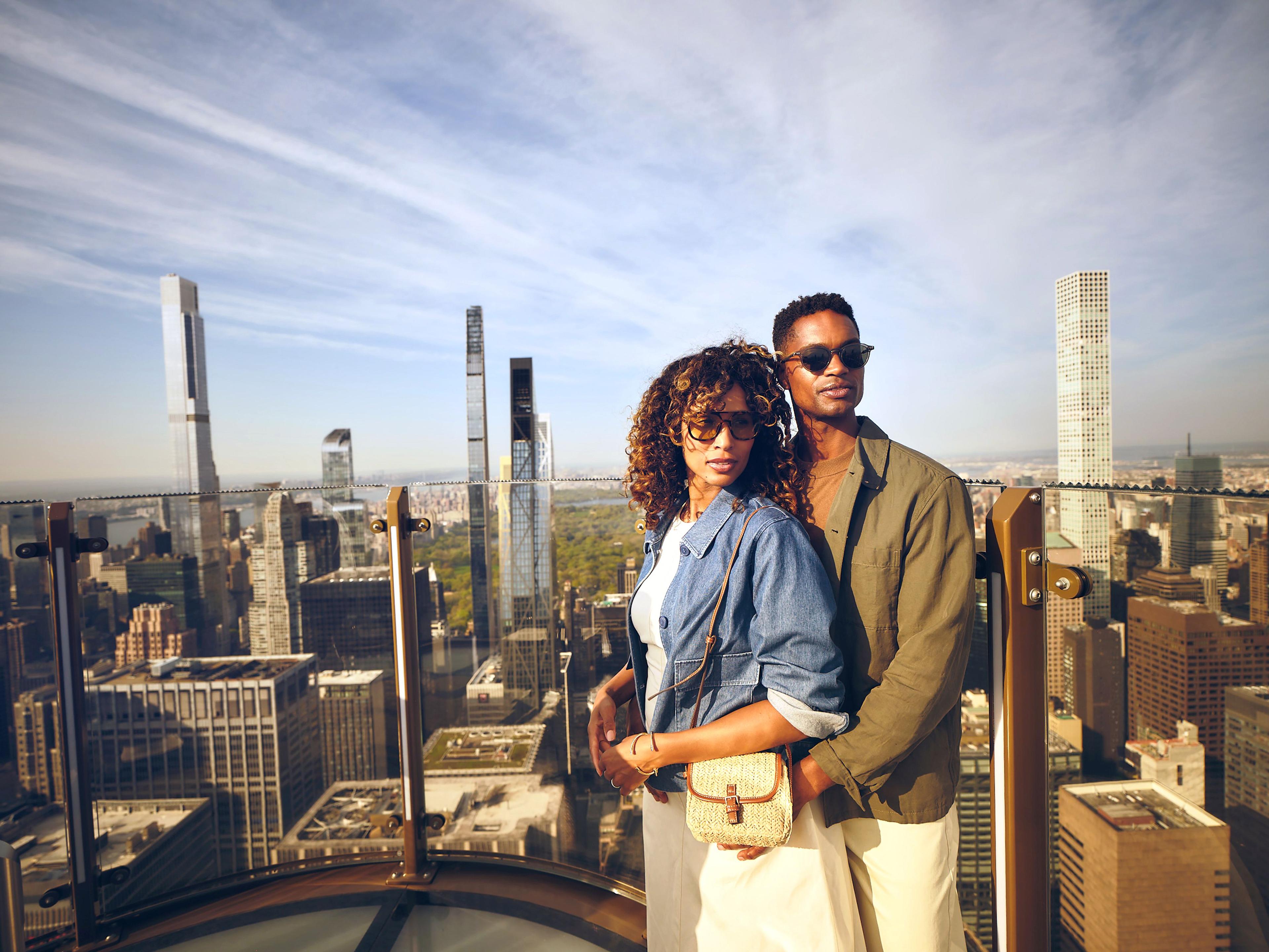 a couple on skylift at top of the rock