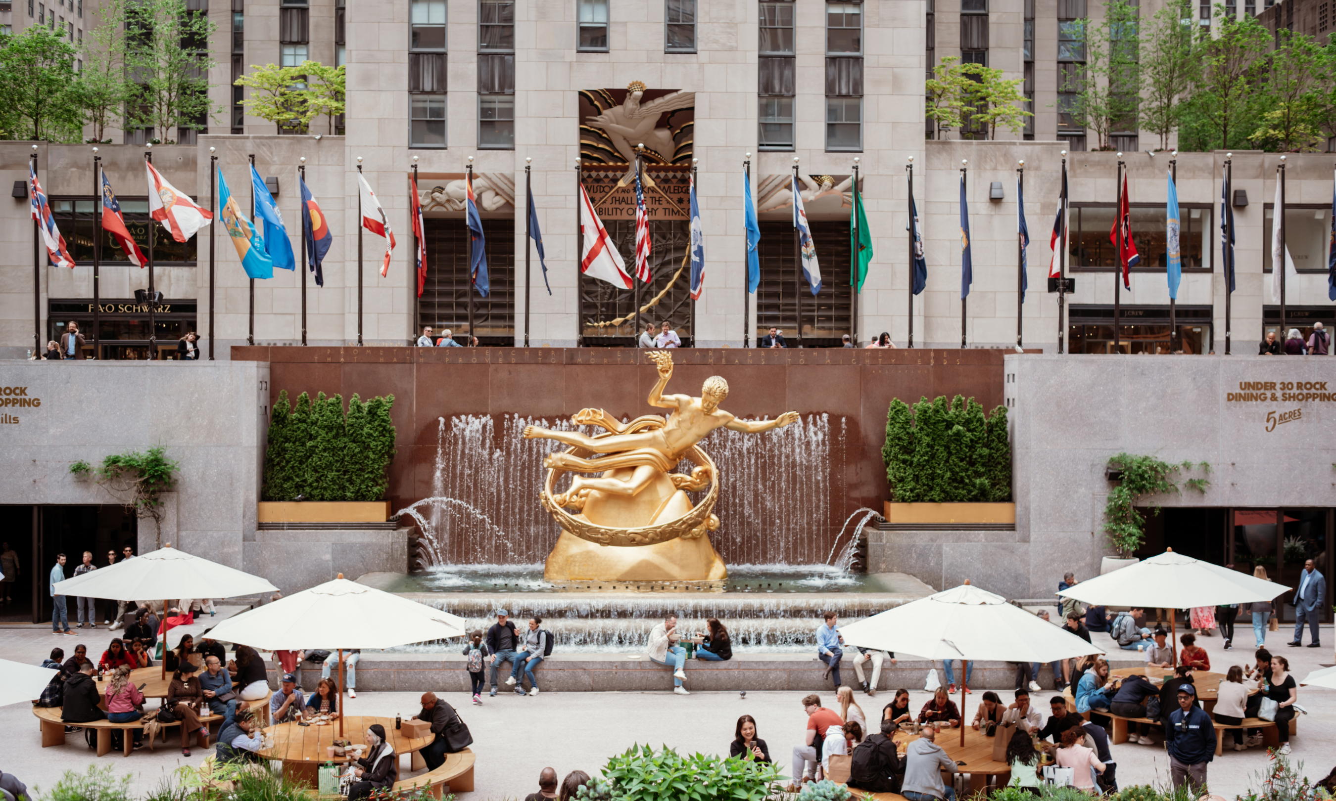 People sitting at tables set up on The Rink at Rockefeller Center