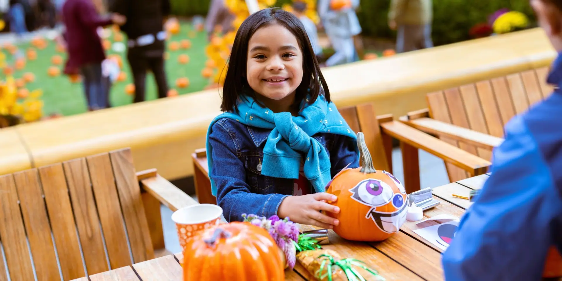 a kid painting a pumpkin