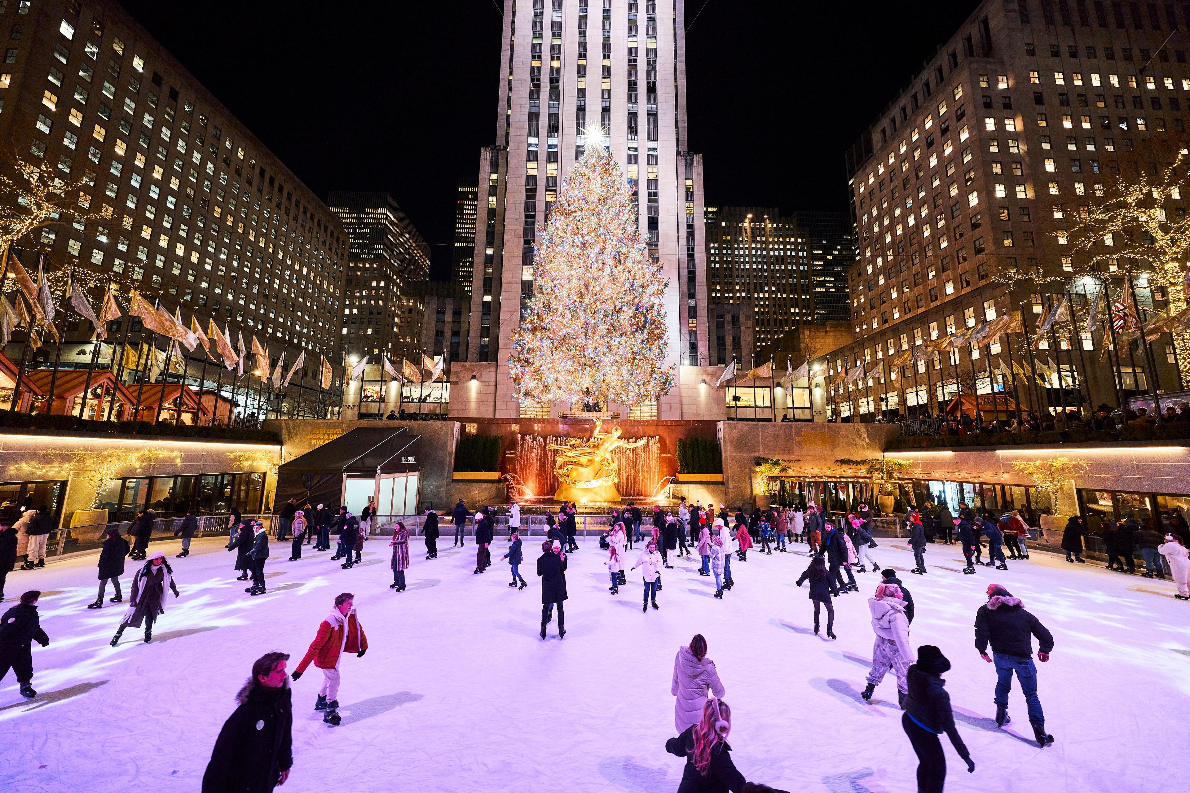 The Rink at night with people skating on the ice