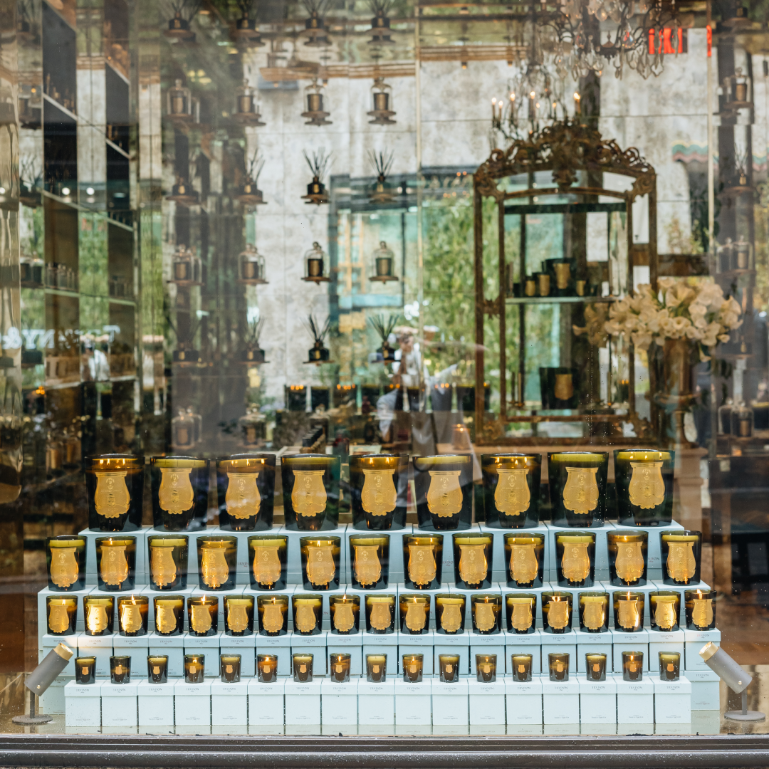 A window display of various candles at Trudon at Rockefeller Center