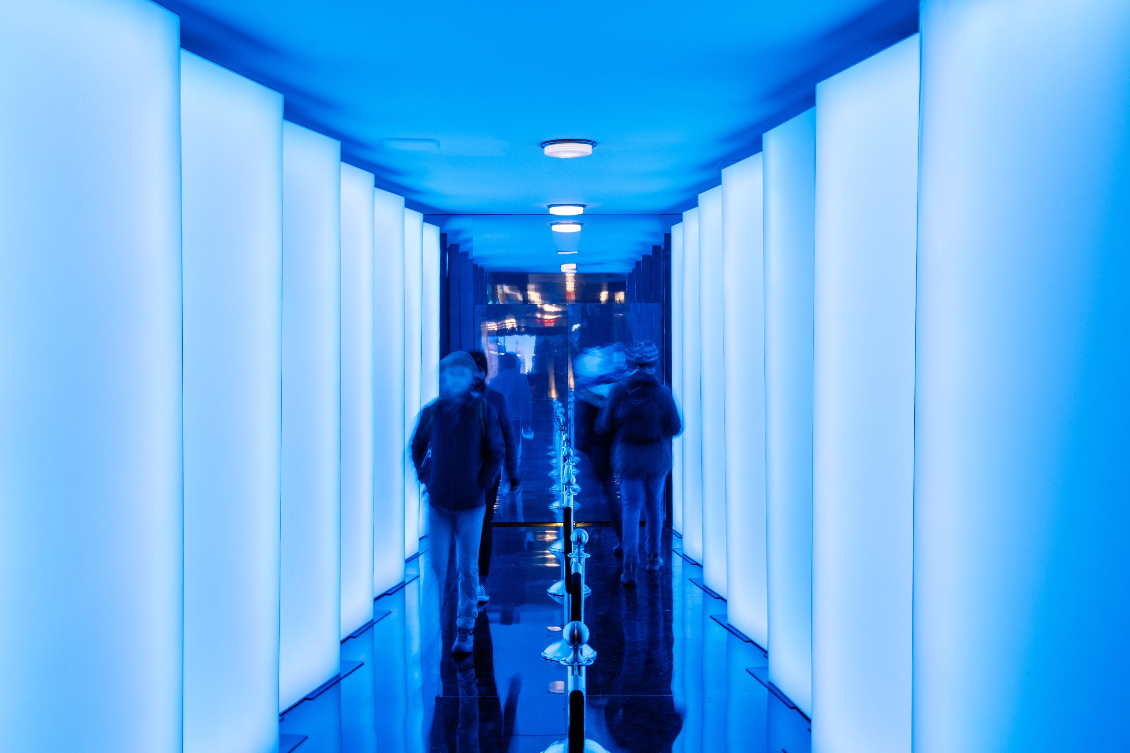 Visitors walking into the "New Frontiers" art exhibit at Top of the Rock