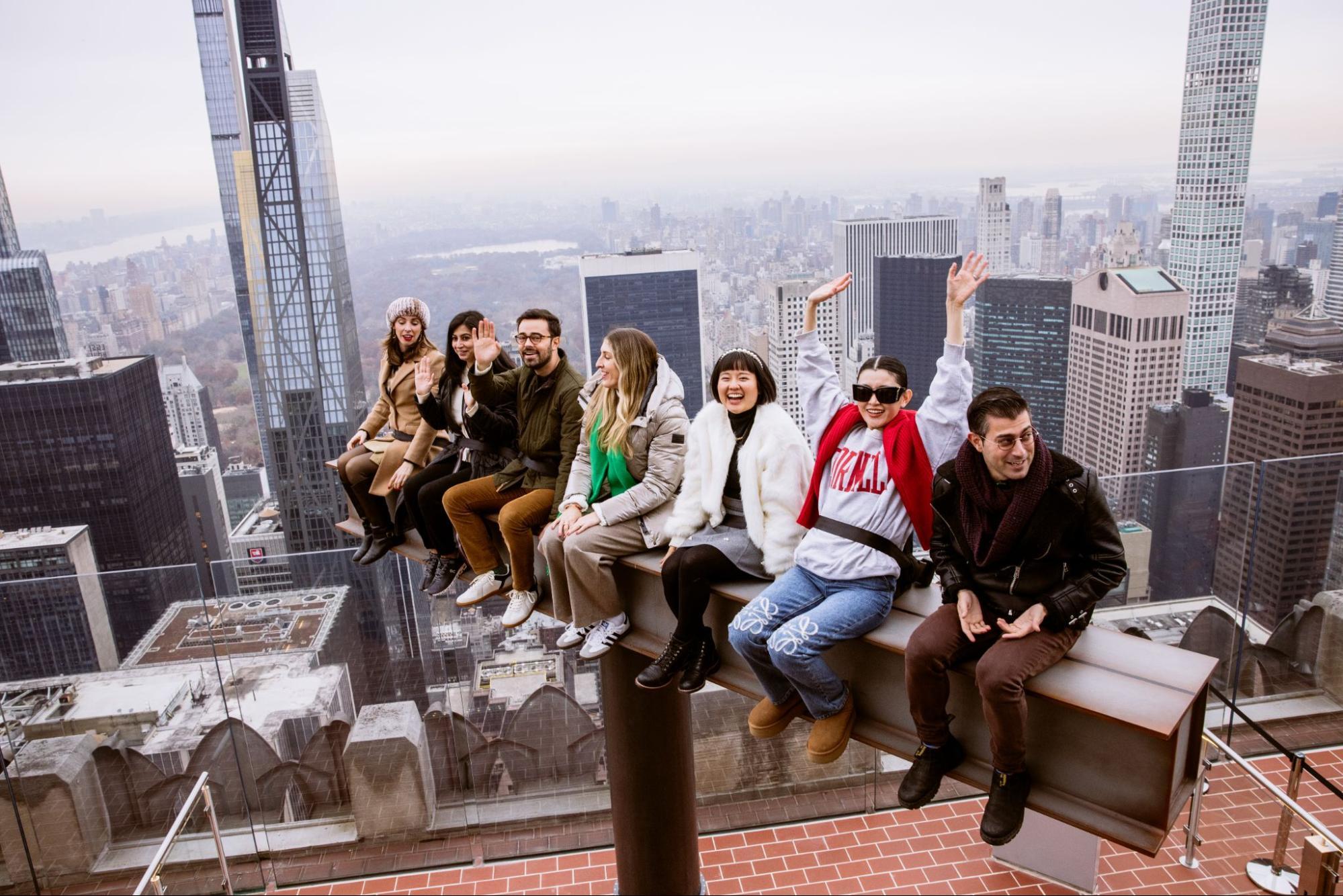 Group sitting on The Beam at Rockefeller Center