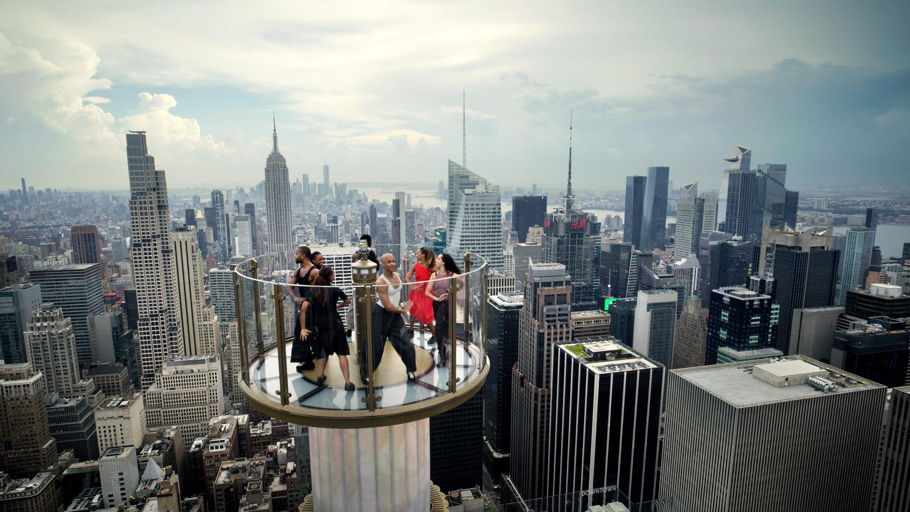 dancers on skylift at top of the rock observation deck
