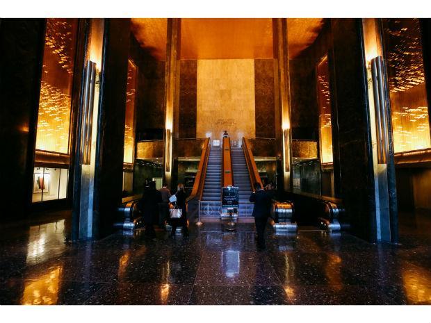 A photo of the escalator in Rockefeller Center surrounded by Michio Ihara's sculpture named Light and Movement inside the Rockefeller International Building.