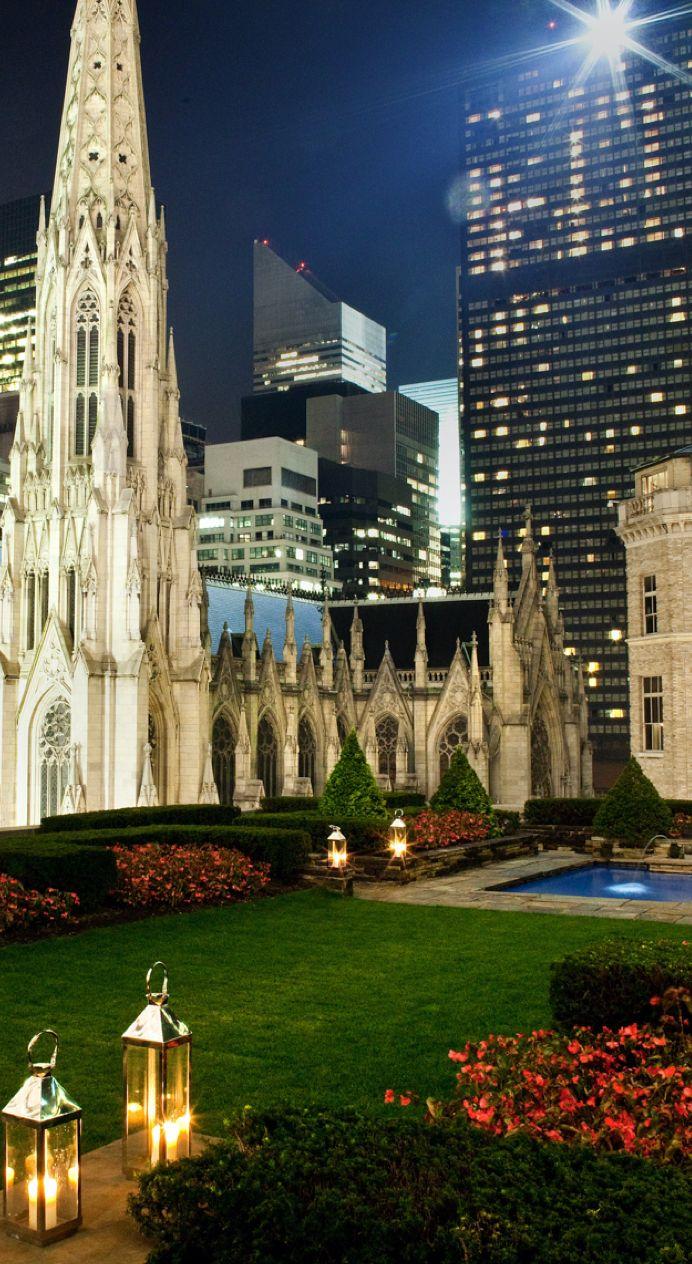 St. Patrick's Cathedral at night beside a rooftop garden