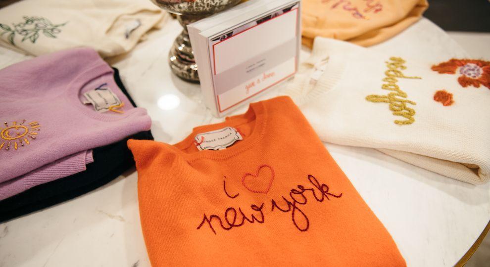 Table of embroidered cashmere sweaters from Lingua Franca