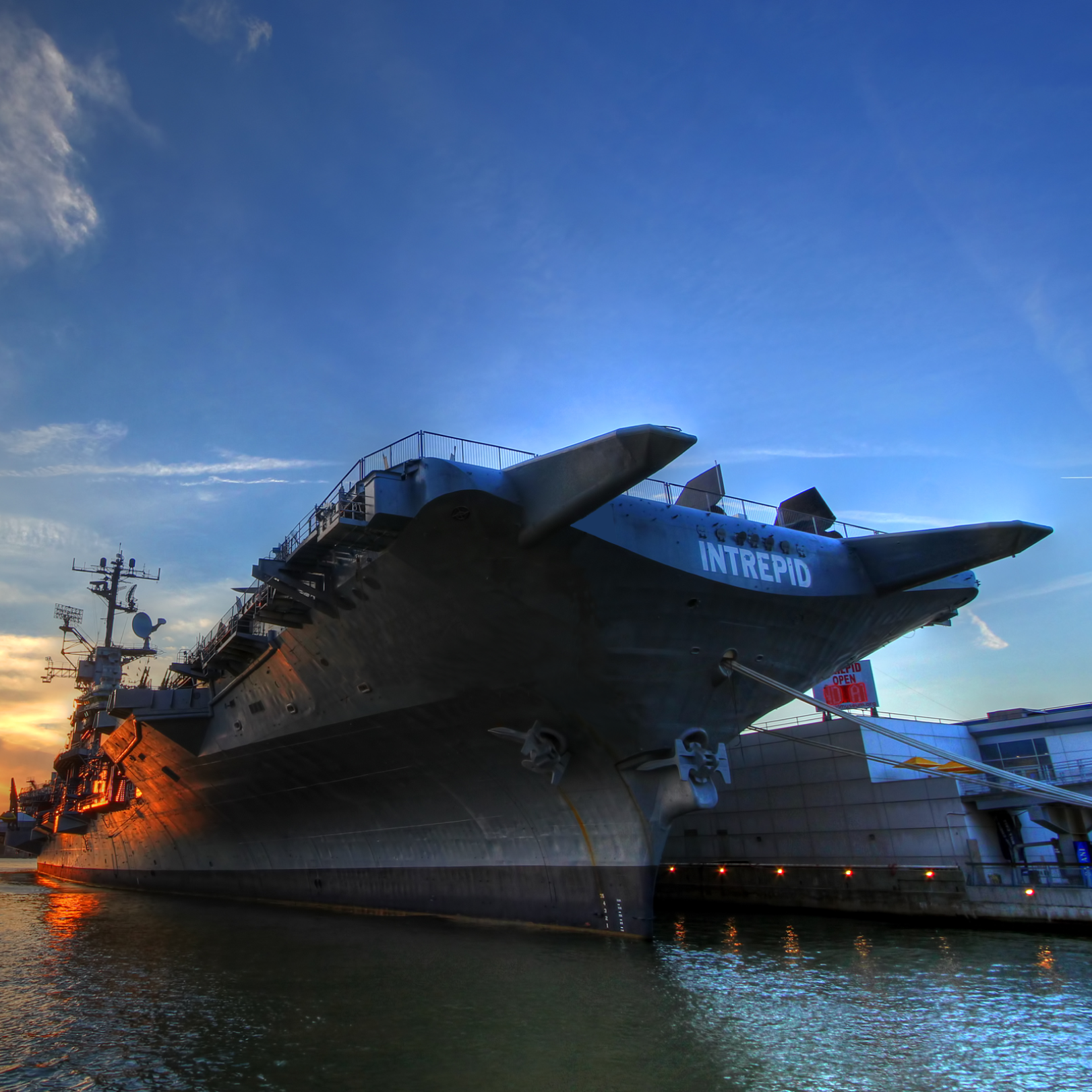 The Intrepid Sea, Air & Space Museum on the Hudson River at sunset