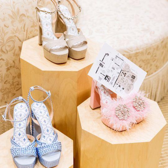 Three pairs of heels from Hill House Home and a map of women-owned businesses at Rockefeller Center