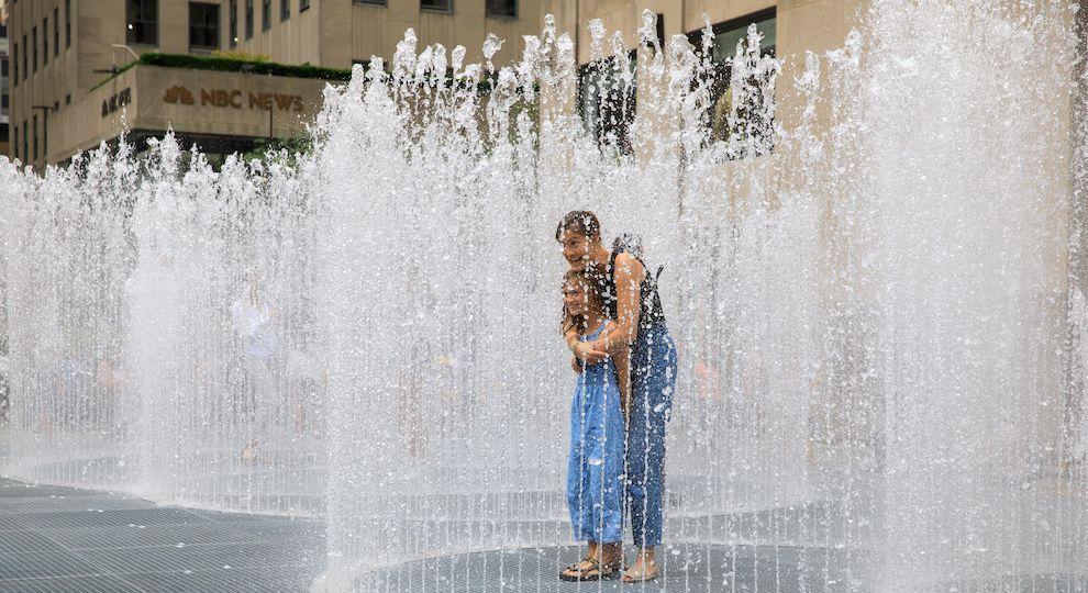 Mother and daughter standing in the middle of artist Jeppe Hein's interactive installation "Changing Spaces" at Rockefeller Center
