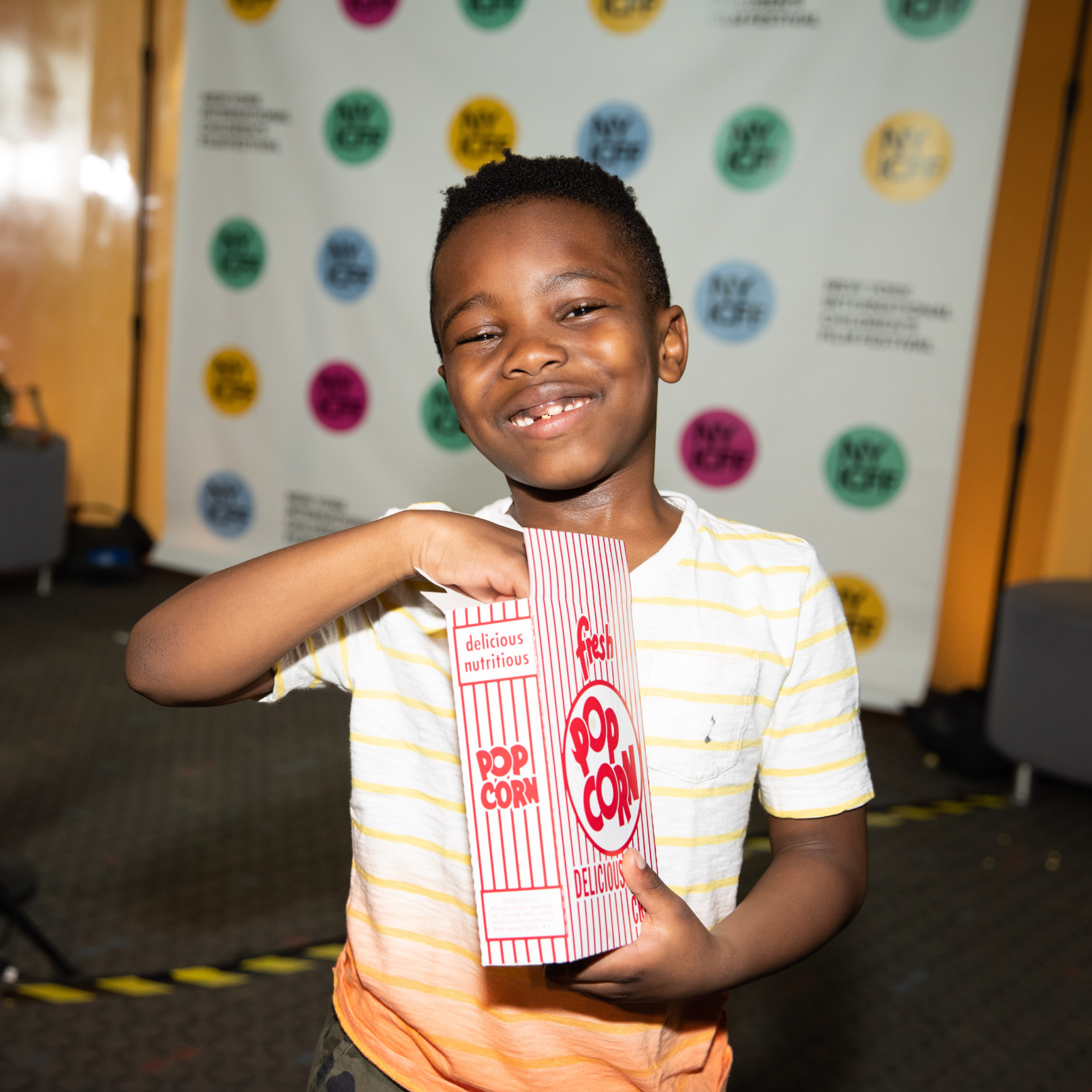 A child eating popcorn at the New York International Children's Film Festival