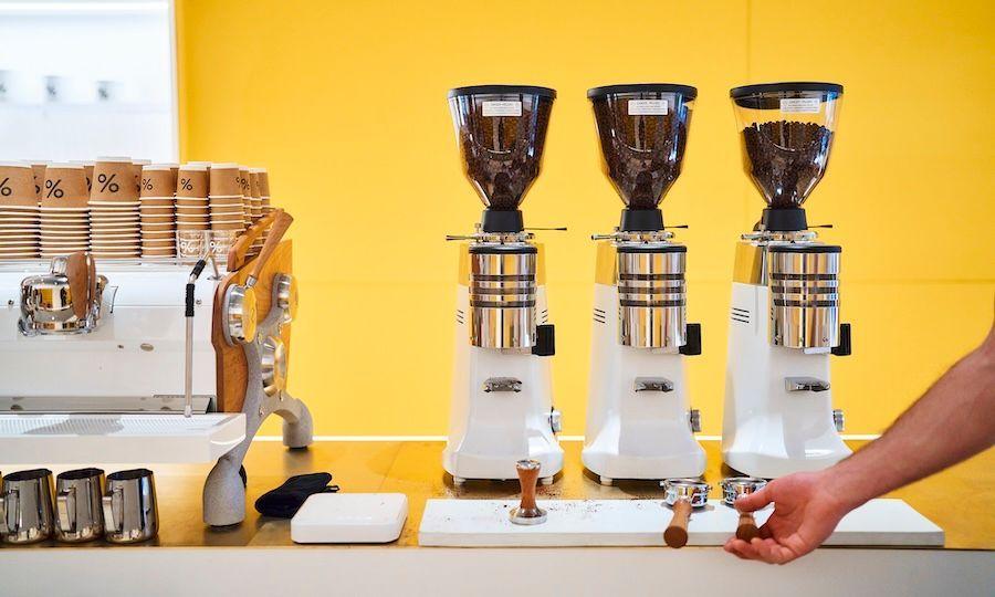 Dispensers filled with coffee grounds at % Arabica at Rockefeller Center