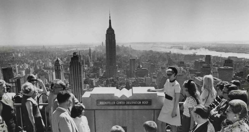 A guided tour at the Top of the Rock overlooking the Empire State Building and lower Manhattan.