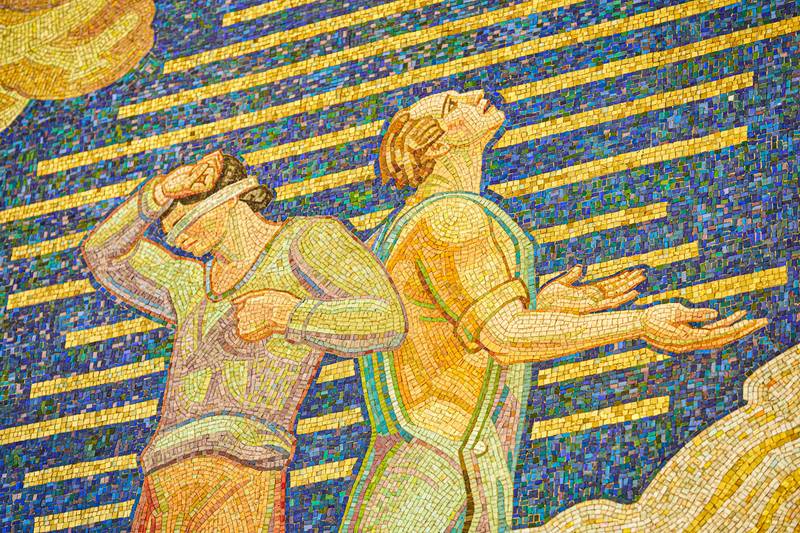 Rockefeller Center mosaic of two men in a field.